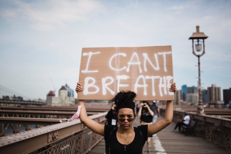 Woman with "I can't breathe" sign