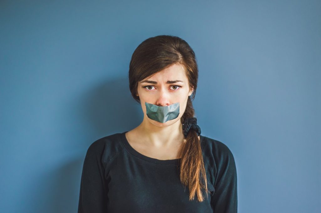 Woman with tape over mouth