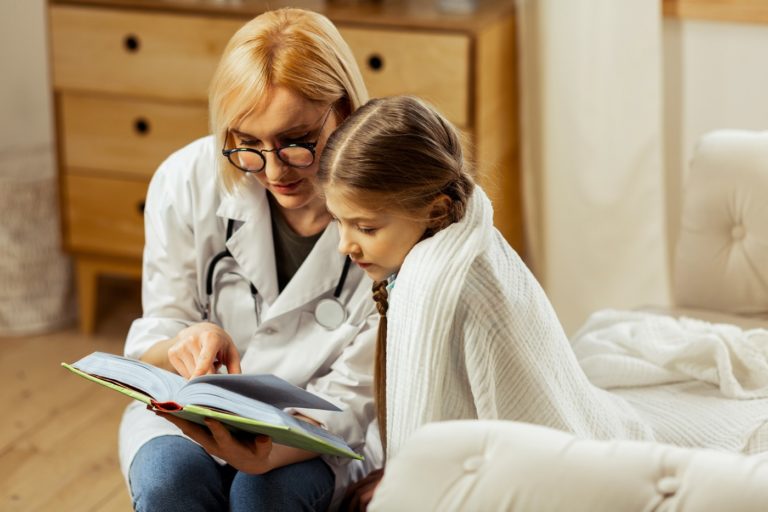 Doctor reading to child