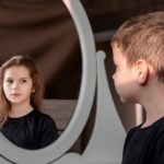 Boy seeing girl in mirror