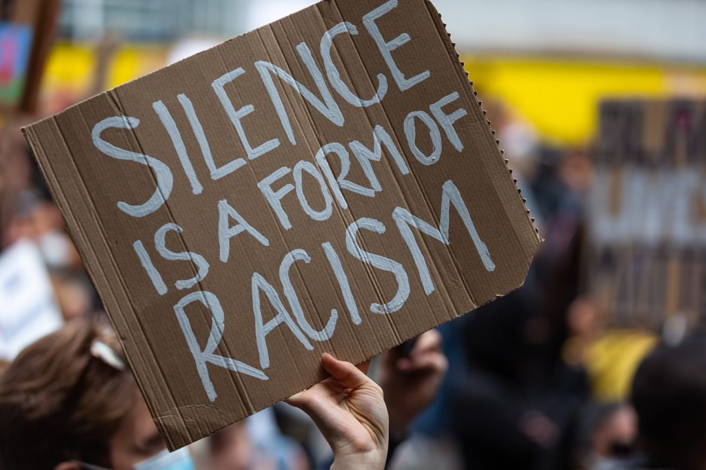 Sign saying "silence is a form of racism"