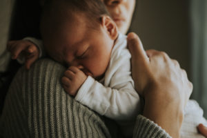 Sleeping baby in mom's arms