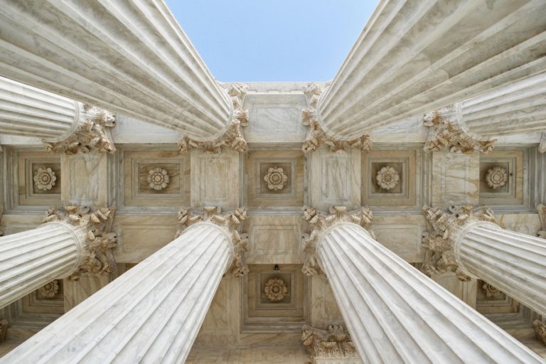 Photo of Supreme Court's exterior with pillars and ceiling