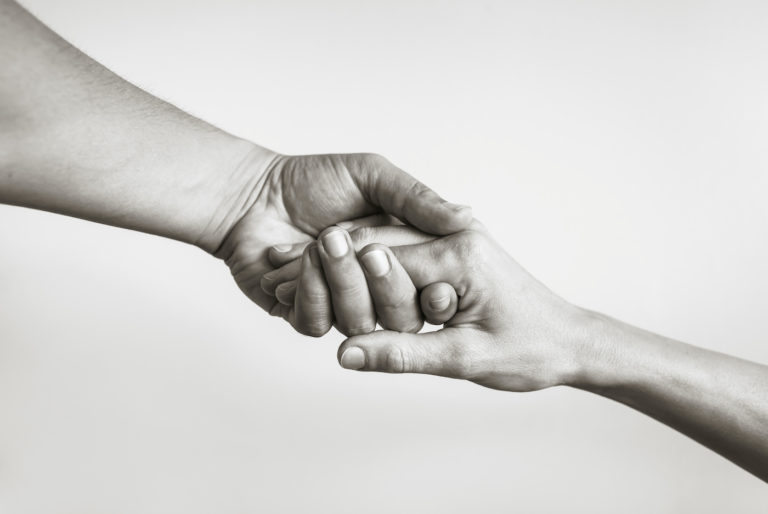 Photo of hand holding black and white