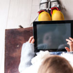 Small child holding an iPad