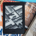 Photo of Kindle on top of books