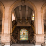 Photo of marble arches with twin stairways and stained glass