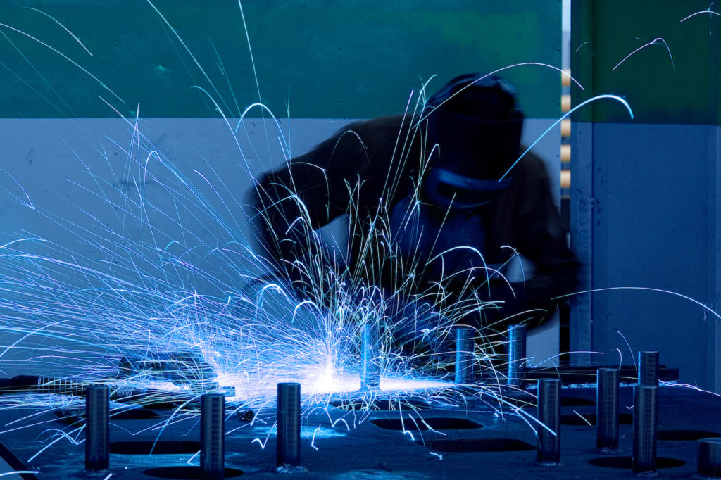 welding worker with sparks arcing