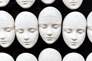 white masks patterned with on a black background