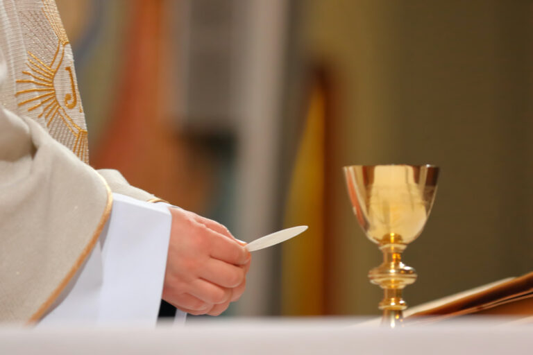 Priest celebrate mass at the church and empty place for text