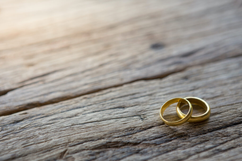 Two gold rings on wooden
