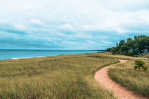 Dramatic landscape of lake michigan dunes and beach in New Buffalo Michigan. Sandy foot path leading to the beach before it rains.