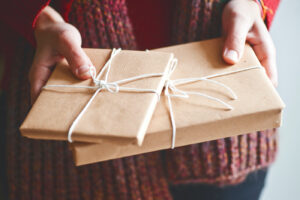 a woman with wrapping cd and book in her hands