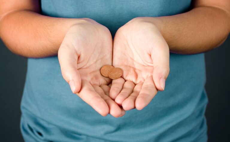 Person holding two pennies