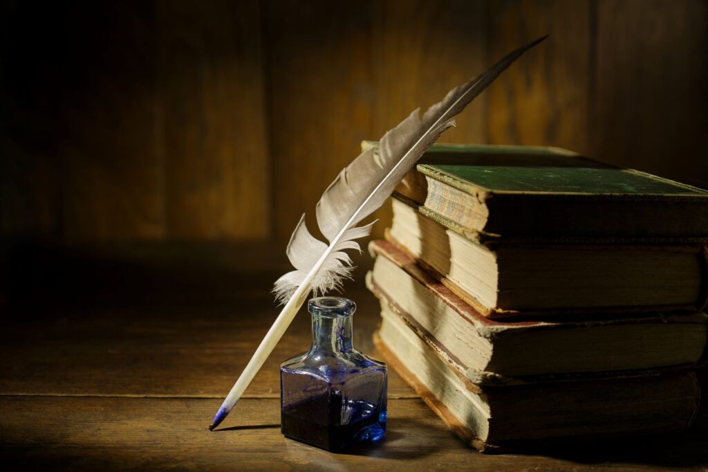 antique books and quill pen
