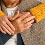 Young person holding an older person's hands