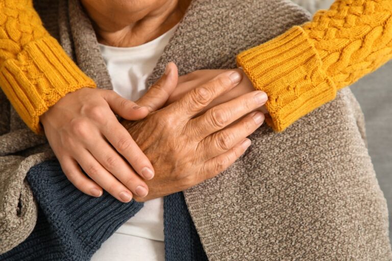 Young person holding an older person's hands