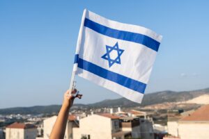 hand holding Israeli flag